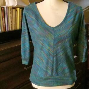 Almost Famous medium mulit  over a teal colored sweater embroidered laced back